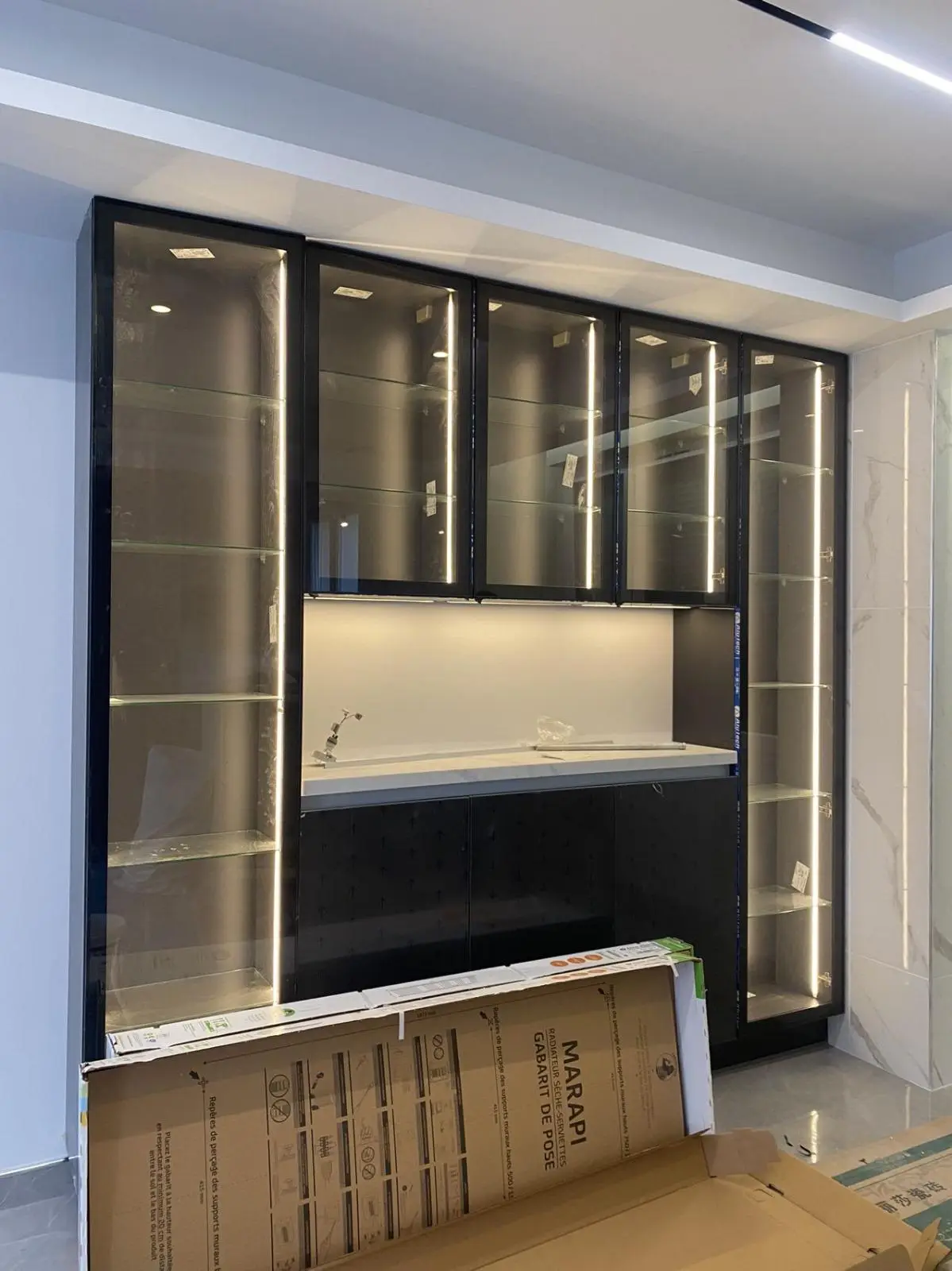 Glazed display cabinetry with bronze framing and integrated LED lighting