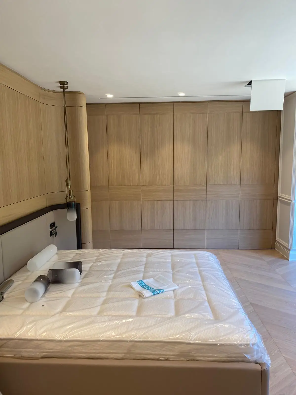 Timber-panelled bedroom wall with integrated lighting and fitted joinery