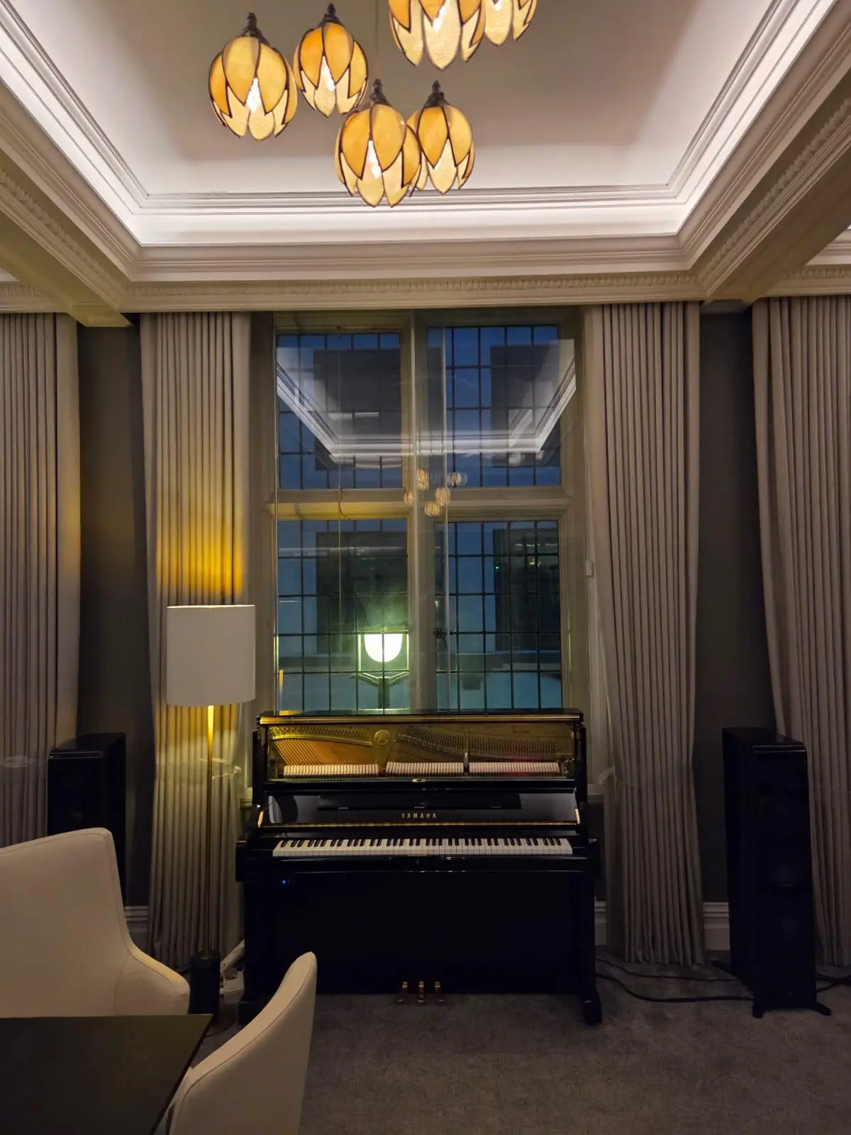 View across the boardroom towards the windows, curtains drawn back to the reveals